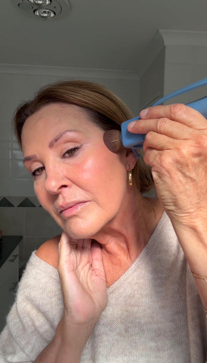 Person holding ergonomic makeup brush with adaptive grip design — accessible beauty tool